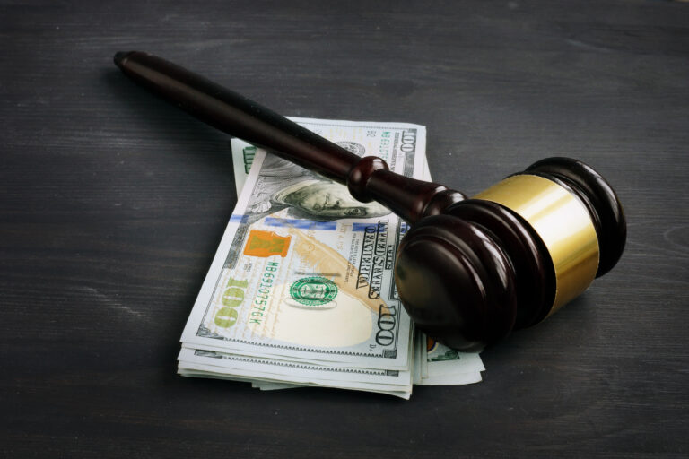 Gavel and money in the court. Penalty or bribe