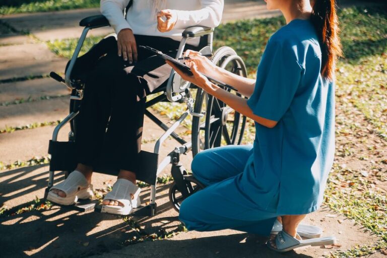 nursing-staff-talking-elderly-person-sitting-wheelchair_265022-73645